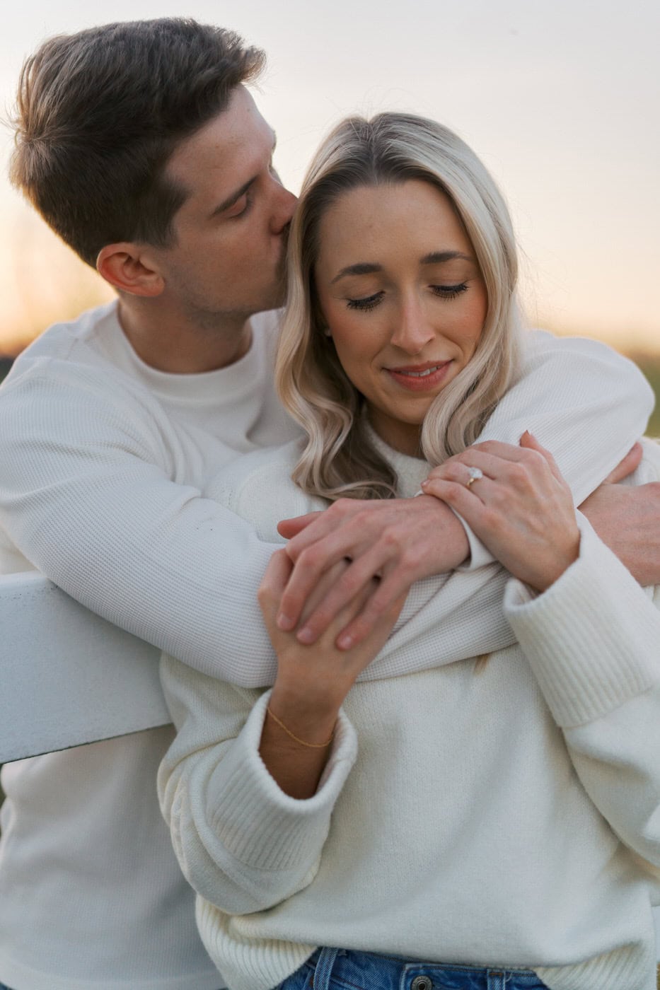 couple cuddled in tight during a soft golden hour